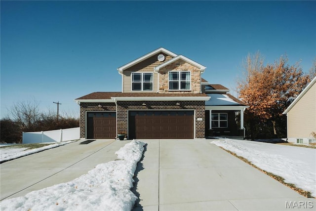 104 Eisenhower Blvd, Troy, IL 62294 - view of front of house with driveway, brick siding, fence, and a garage