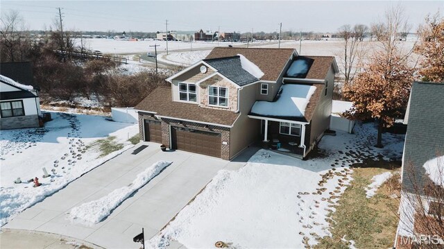 104 Eisenhower Blvd, Troy, IL 62294 - view of front of house featuring an attached garage, driveway, a shingled roof, and stone siding