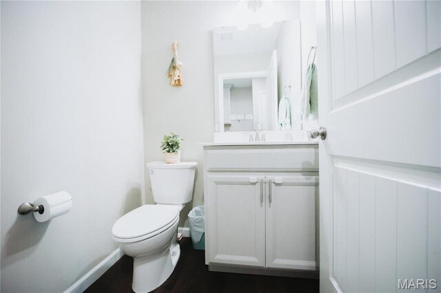 104 Eisenhower Blvd, Troy, IL 62294 - bathroom with toilet, vanity, and wood finished floors