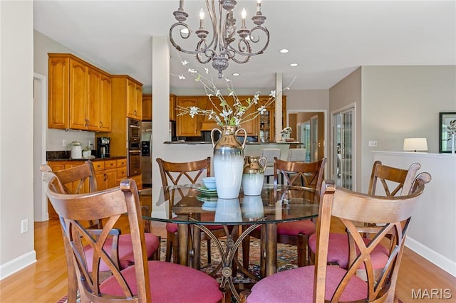 dining area featuring a chandelier, light wood-style floors, baseboards, and recessed lighting