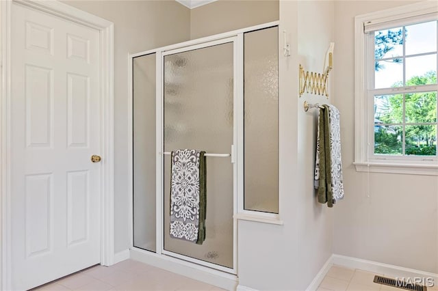 bathroom with baseboards, a stall shower, and tile patterned flooring