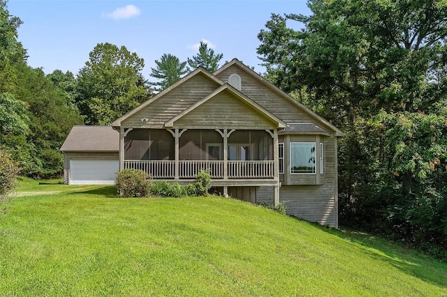 view of front facade with a sunroom, a front lawn, and a garage