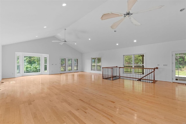 unfurnished living room with a ceiling fan, high vaulted ceiling, light wood-type flooring, and recessed lighting