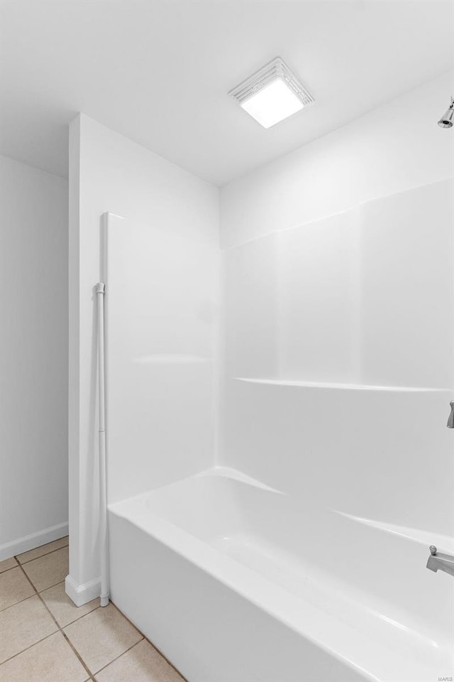 full bathroom featuring tile patterned floors, baseboards, and washtub / shower combination