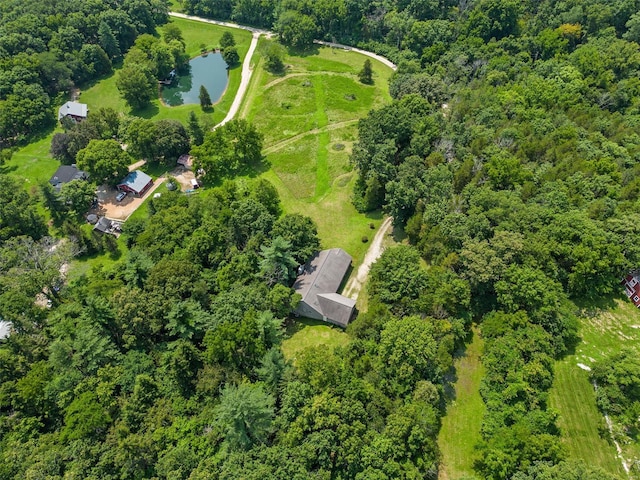 aerial overview of property's location with a large body of water and a heavily wooded area
