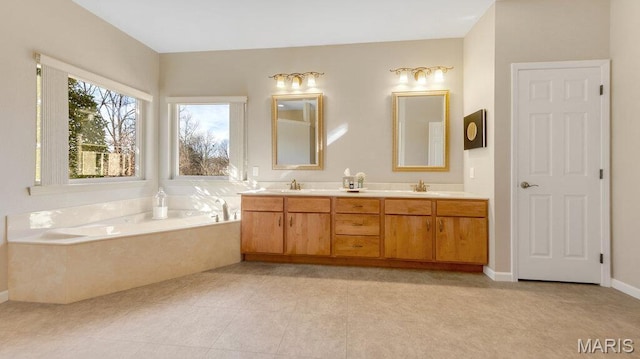 full bathroom featuring double vanity, a bath, and tile patterned floors