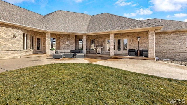 back of property with an outdoor hangout area, brick siding, a yard, roof with shingles, and a patio