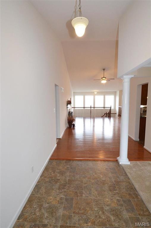 936 Palamino Path, High Ridge, MO 63049 - hallway with ornate columns, high vaulted ceiling, stone finish floors, and baseboards
