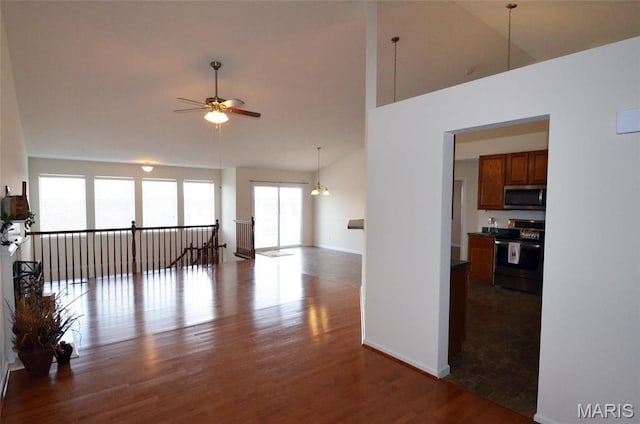 936 Palamino Path, High Ridge, MO 63049 - empty room featuring a ceiling fan, wood finished floors, high vaulted ceiling, and baseboards