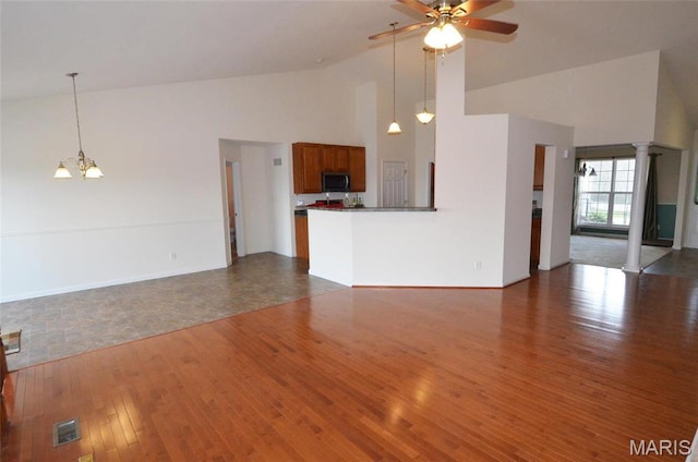936 Palamino Path, High Ridge, MO 63049 - unfurnished living room with high vaulted ceiling, ceiling fan, wood finished floors, a chandelier, and baseboards