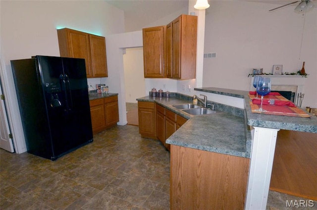936 Palamino Path, High Ridge, MO 63049 - kitchen with black fridge with ice dispenser, a sink, a peninsula, stone finish floors, and brown cabinets