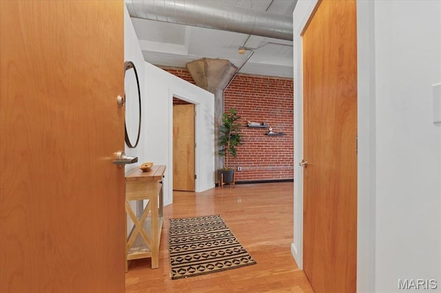 1619 Washington Ave Unit 805, Saint Louis, MO 63103 - hallway featuring brick wall and wood finished floors