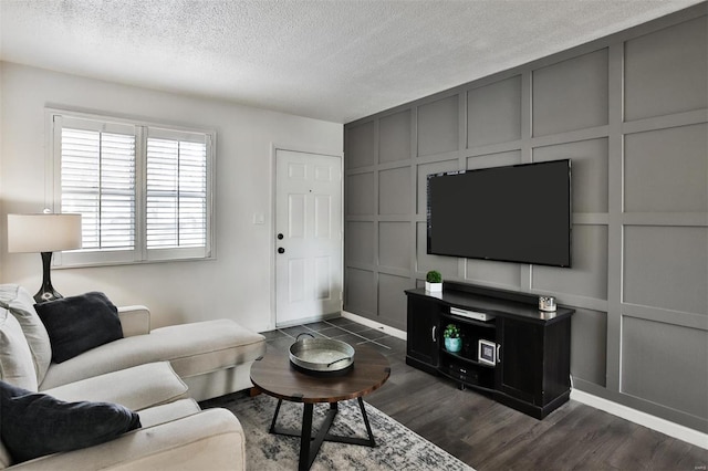 9154 Eager Rd, Saint Louis, MO 63144 - living area with a decorative wall, dark wood-style flooring, a textured ceiling, and baseboards