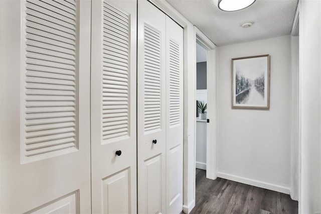 9154 Eager Rd, Saint Louis, MO 63144 - hall with dark wood finished floors, baseboards, and a textured ceiling