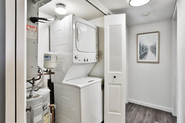 9154 Eager Rd, Saint Louis, MO 63144 - laundry area with stacked washer / drying machine, wood finished floors, and baseboards