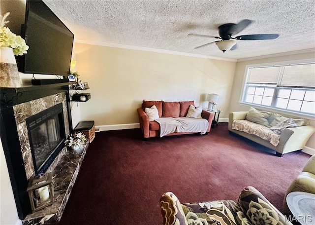 125 Hull Ave, Saint Louis, MO 63119 - carpeted living room featuring ornamental molding, a ceiling fan, a textured ceiling, a fireplace with raised hearth, and baseboards