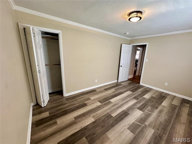 125 Hull Ave, Saint Louis, MO 63119 - unfurnished bedroom featuring crown molding, wood finished floors, baseboards, and a closet