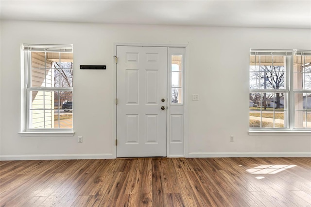 entryway with wood finished floors, plenty of natural light, and baseboards