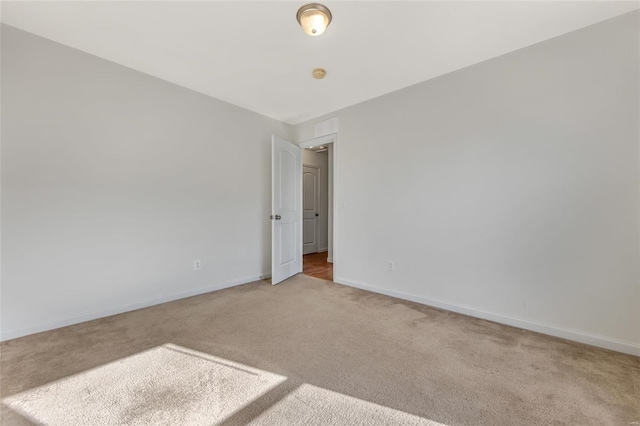 carpeted empty room with baseboards
