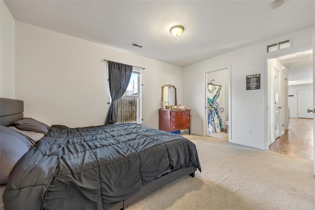 bedroom with light carpet and baseboards