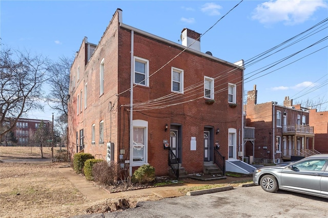 2005 Lynch St Unit C, Saint Louis, MO 63118 - multi unit property with entry steps, brick siding, a chimney, and uncovered parking