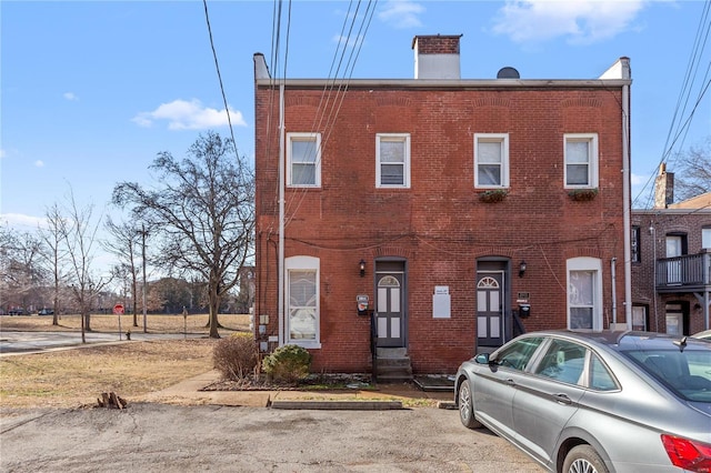2005 Lynch St Unit C, Saint Louis, MO 63118 - view of property with a chimney, brick siding, and entry steps