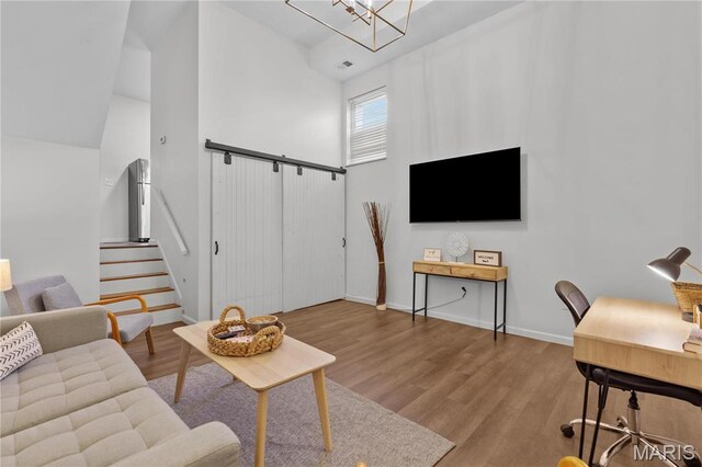 2005 Lynch St Unit C, Saint Louis, MO 63118 - living area featuring wood finished floors, stairs, a chandelier, and baseboards