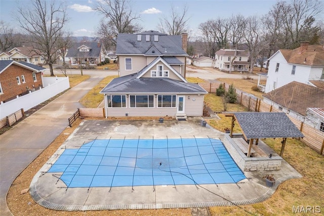 616 W Columbia St, Farmington, MO 63640 - rear view of house with a residential view, a shingled roof, a fenced backyard, and a patio area