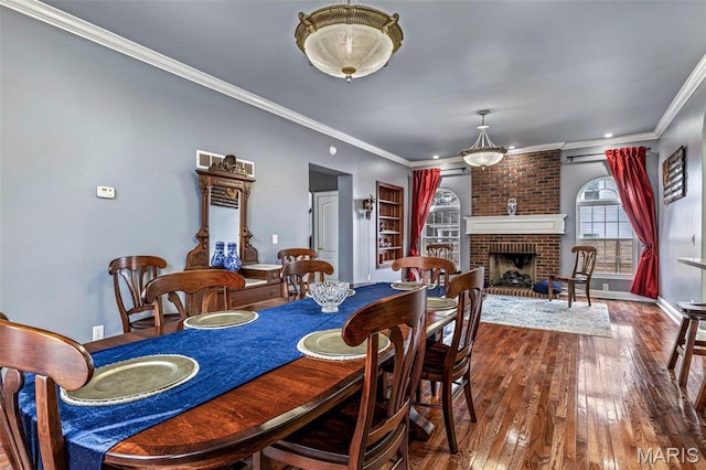 616 W Columbia St, Farmington, MO 63640 - dining space with wood-type flooring, ornamental molding, and a fireplace