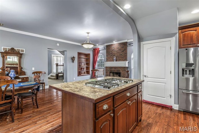 616 W Columbia St, Farmington, MO 63640 - kitchen with appliances with stainless steel finishes, a kitchen island, a fireplace, dark wood-style floors, and ornamental molding