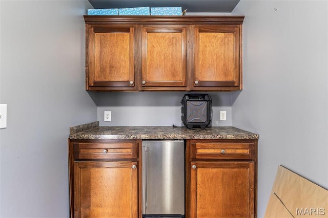 616 W Columbia St, Farmington, MO 63640 - kitchen with refrigerator, brown cabinetry, and dark countertops