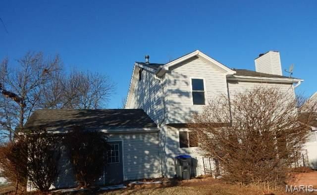 16 Garden Gate Ct, Saint Peters, MO 63304 - rear view of house with a chimney
