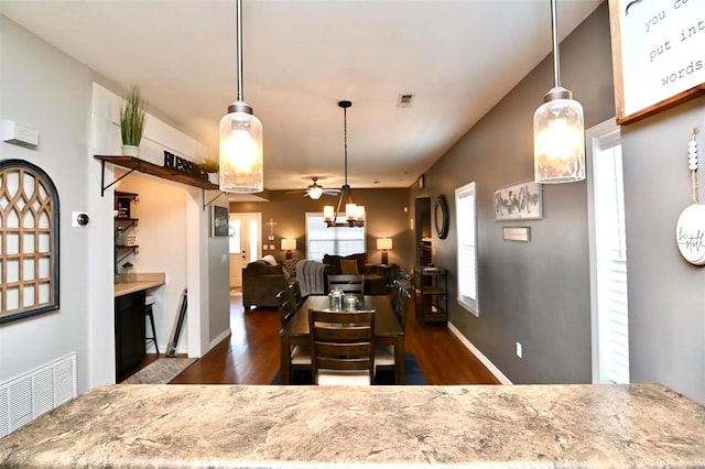 dining room with ceiling fan, dark wood-style floors, and baseboards