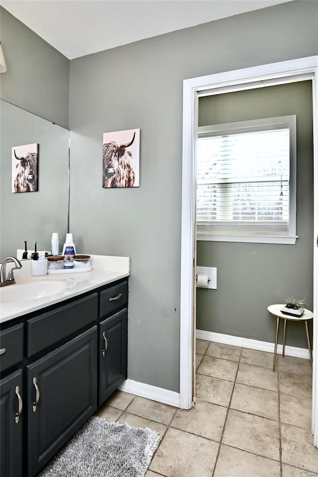 bathroom featuring vanity, tile patterned flooring, and baseboards