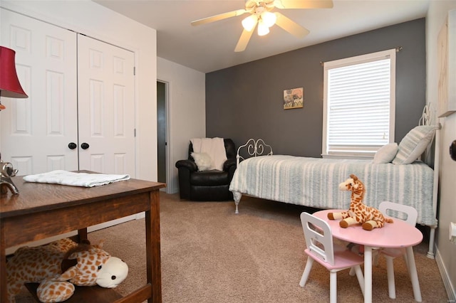 carpeted bedroom with a closet and ceiling fan