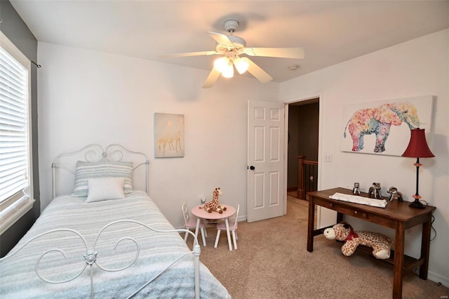 bedroom with multiple windows, light carpet, ceiling fan, and baseboards