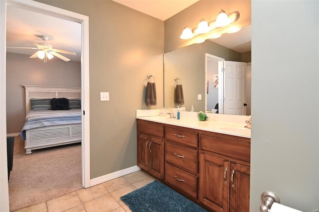 full bathroom featuring connected bathroom, tile patterned flooring, double vanity, ceiling fan, and baseboards