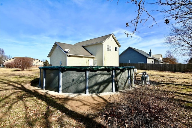 view of home's exterior with fence and metal roof