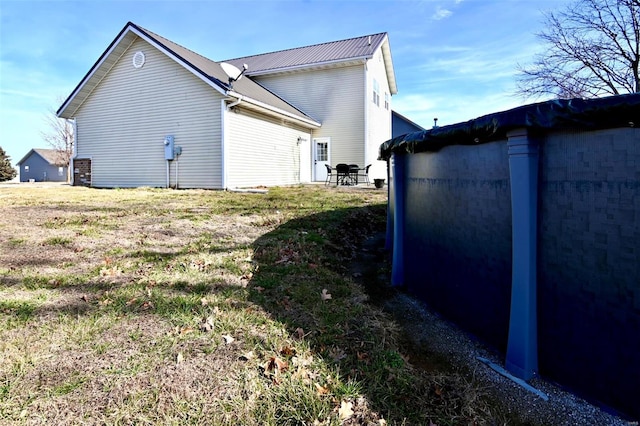 view of property exterior featuring metal roof