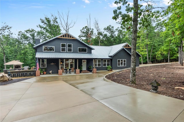 6060 N Bend Dr, Perryville, MO 63775 - craftsman inspired home with a porch, metal roof, a chimney, and concrete driveway
