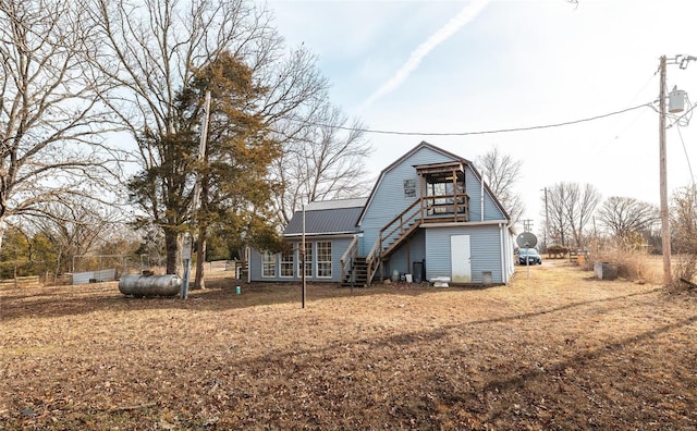 20020 Buffer Ln, Waynesville, MO 65583 - rear view of house with stairs, a gambrel roof, and metal roof
