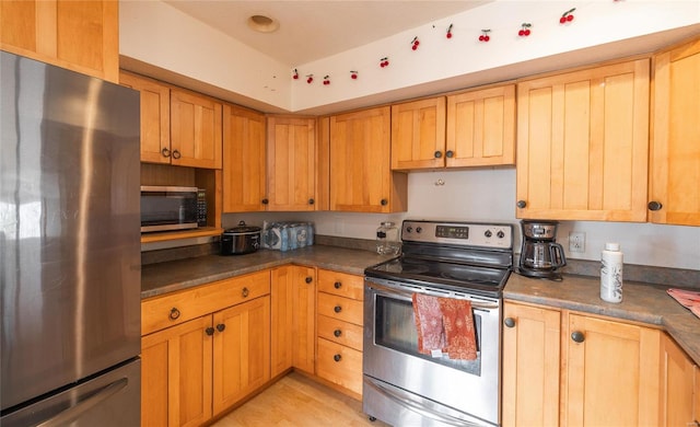20020 Buffer Ln, Waynesville, MO 65583 - kitchen featuring stainless steel appliances, dark countertops, and light wood finished floors