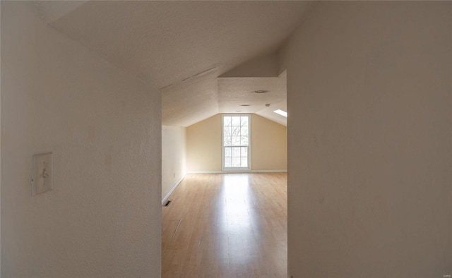 20020 Buffer Ln, Waynesville, MO 65583 - additional living space with vaulted ceiling, light wood-style floors, and baseboards