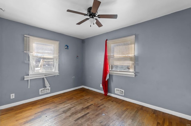 unfurnished room with baseboards, wood-type flooring, and ceiling fan