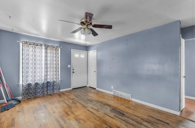 entrance foyer featuring a ceiling fan, hardwood / wood-style flooring, and baseboards