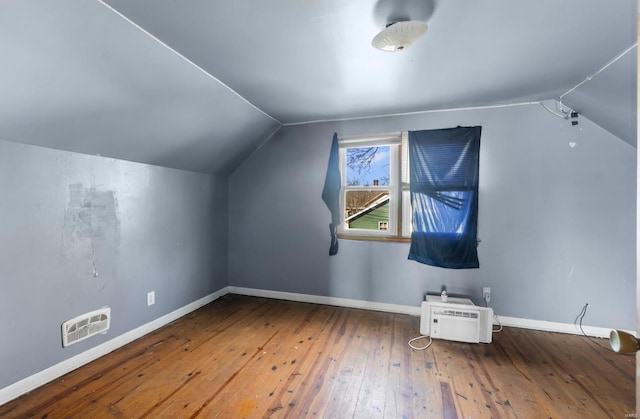 bonus room featuring vaulted ceiling, hardwood / wood-style floors, and baseboards