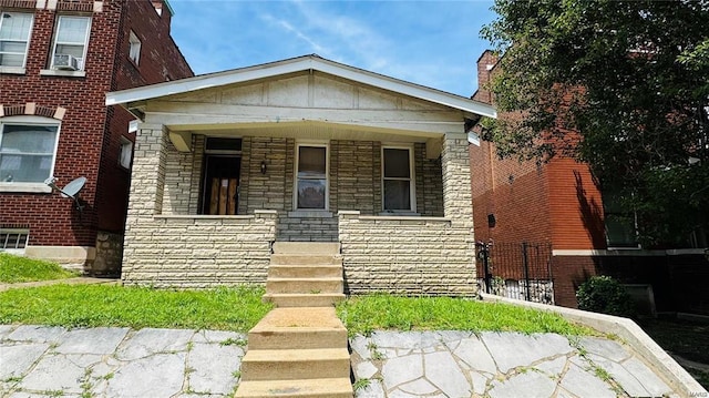 3449 Miami St, Saint Louis, MO 63118 - view of front of house featuring stone siding, covered porch, and cooling unit