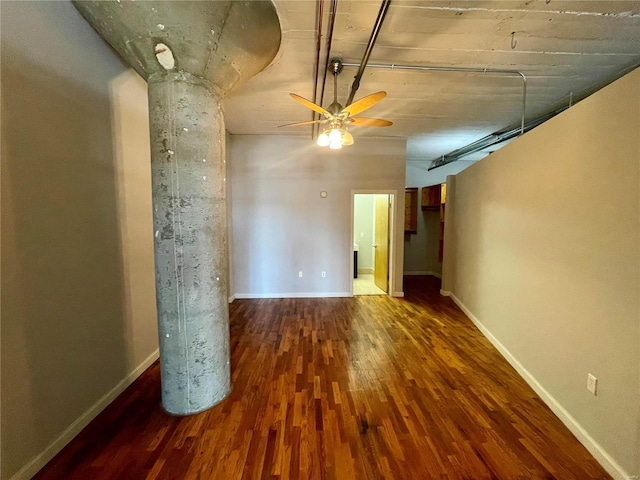unfurnished room featuring wood finished floors, ceiling fan, and baseboards
