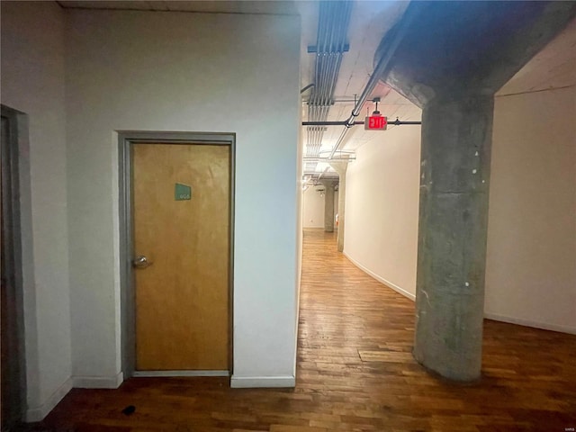 hallway with wood finished floors and baseboards