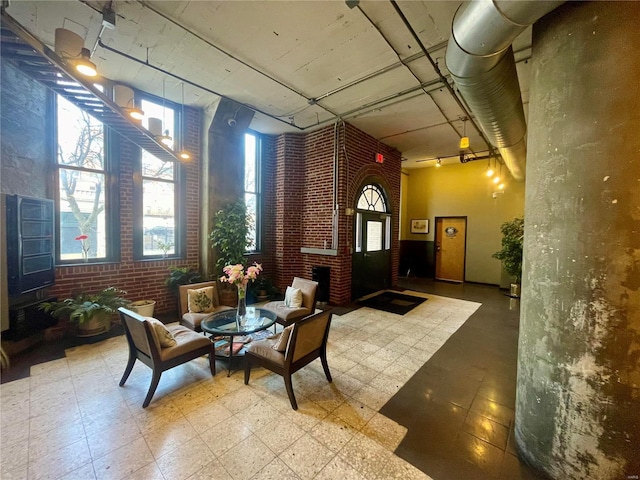 lobby featuring brick wall